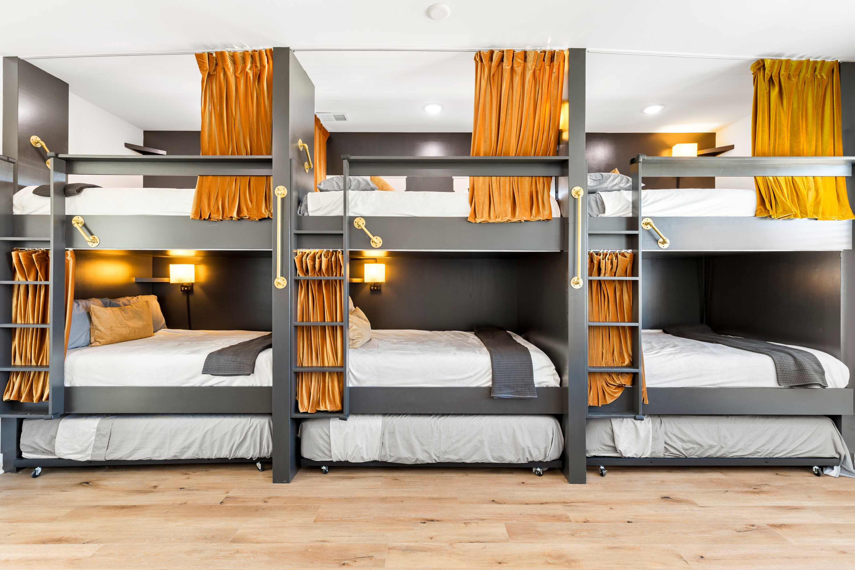 Luxury bunk bed room with dark accents and gold curtains